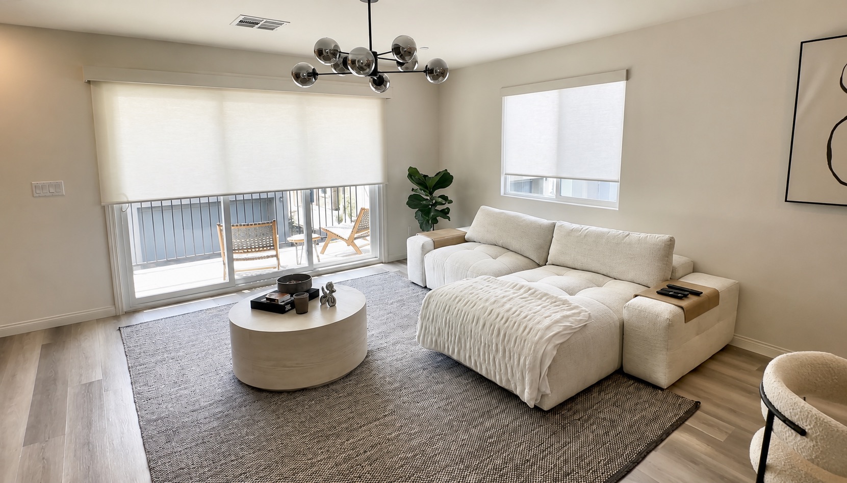 Living room with roller shades on the sliding door and window
