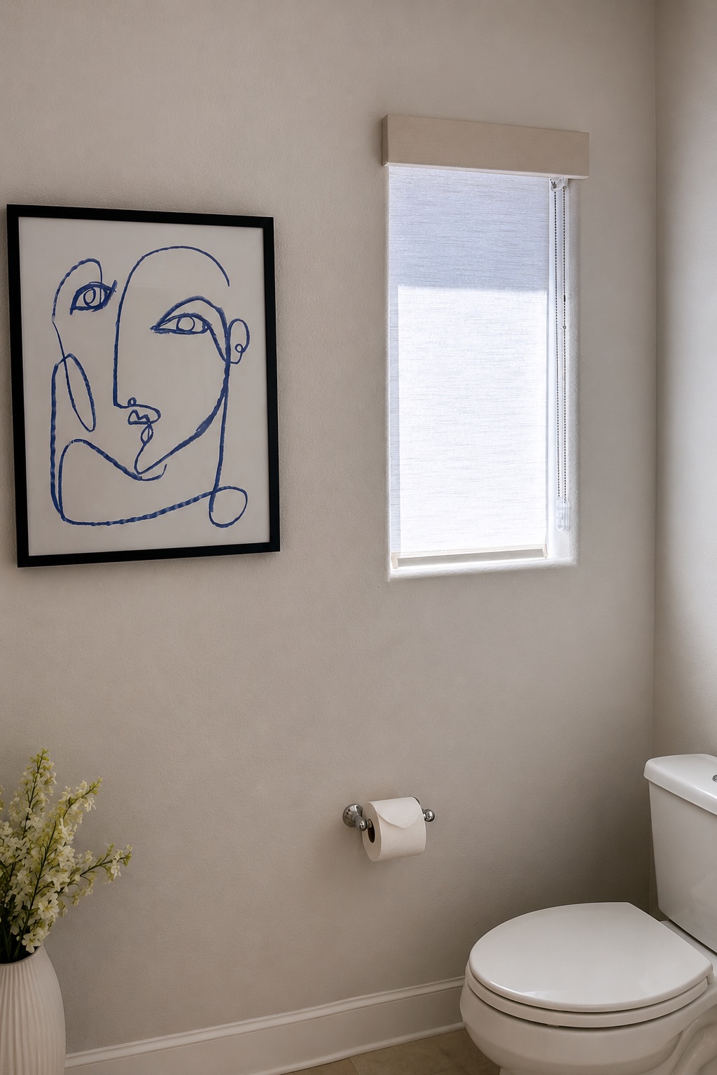 Bathroom window with a light-filtering roller shade