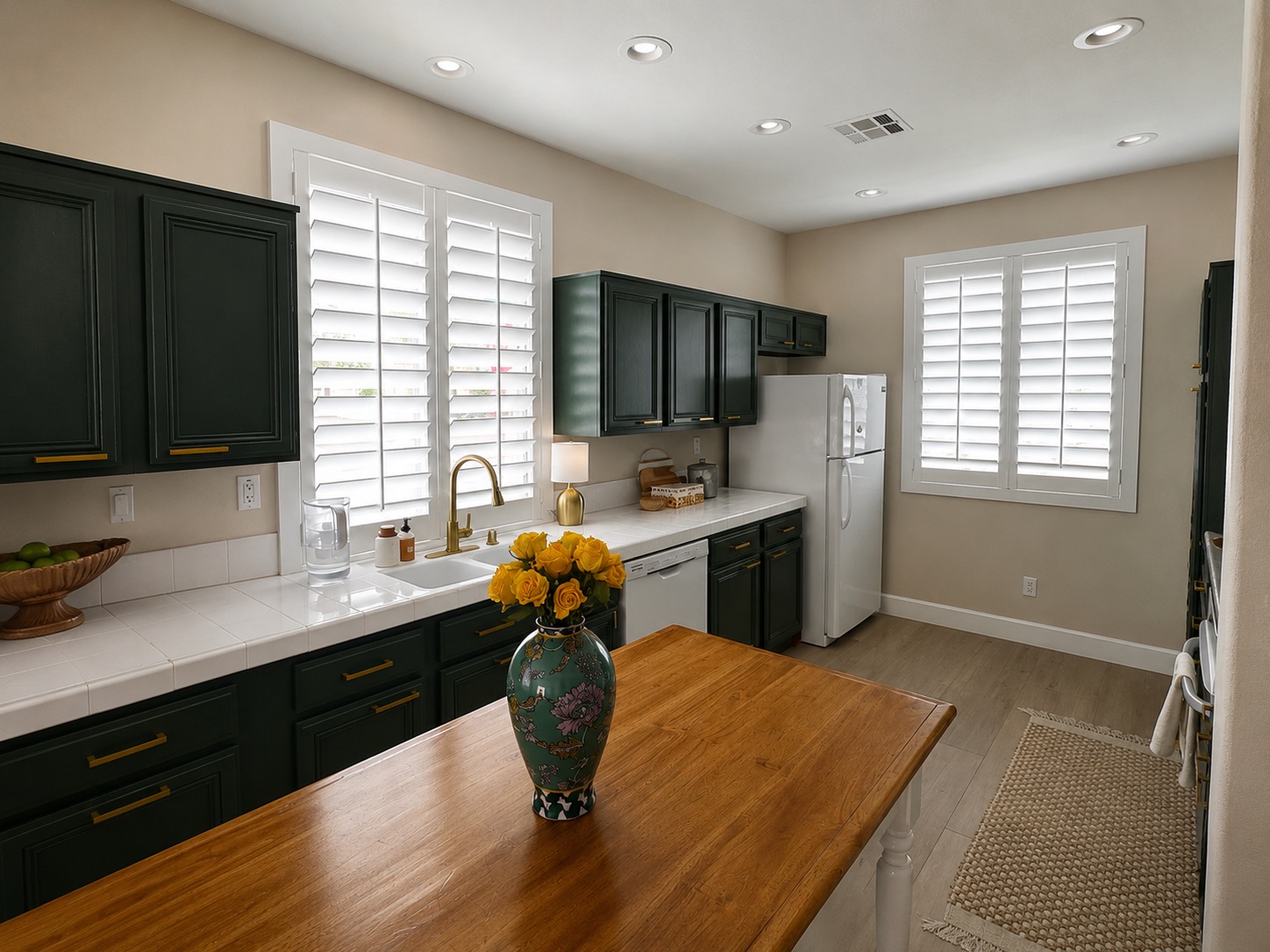 Kitchen with plantation shutters at the sink windows